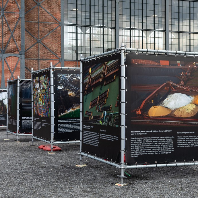 Quadratische Leinwände mit Bildern und Texten zur Ausstellung Hidden Coast vor der Maschinenhalle. (öffnet vergrößerte Bildansicht)